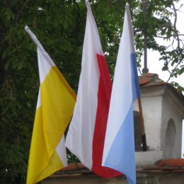 Papal, Polish, Mary flags on wall at church